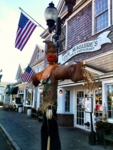 A creative scarecrow in front of Liam Maguire's Pub on Main Street in Falmouth Village
